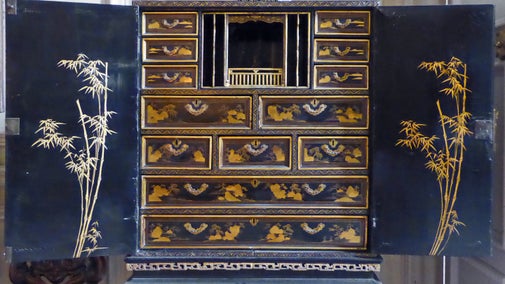 Inside of a late 17th-century black lacquer Chinese cabinet at Dyrham Park, South Gloucestershire